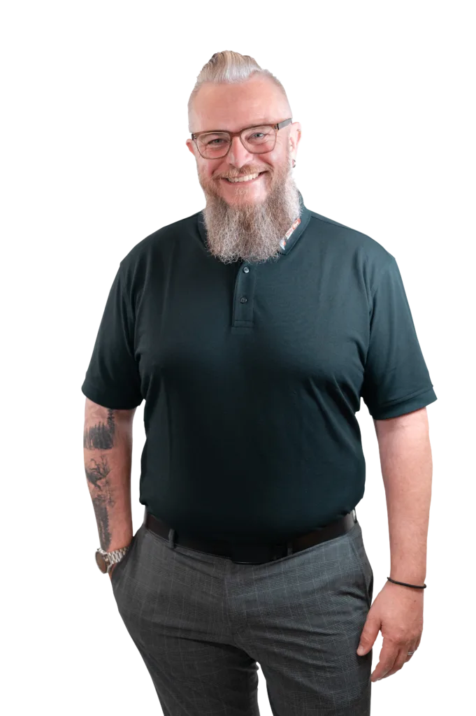 Person mit Brille schaut lächelnd in die Kamera.